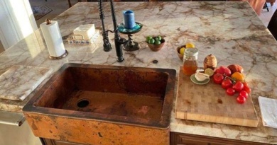 Large custom copper farmhouse sink in kitchen