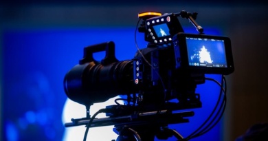 Alt text: A professional video camera set up in a production studio for business content